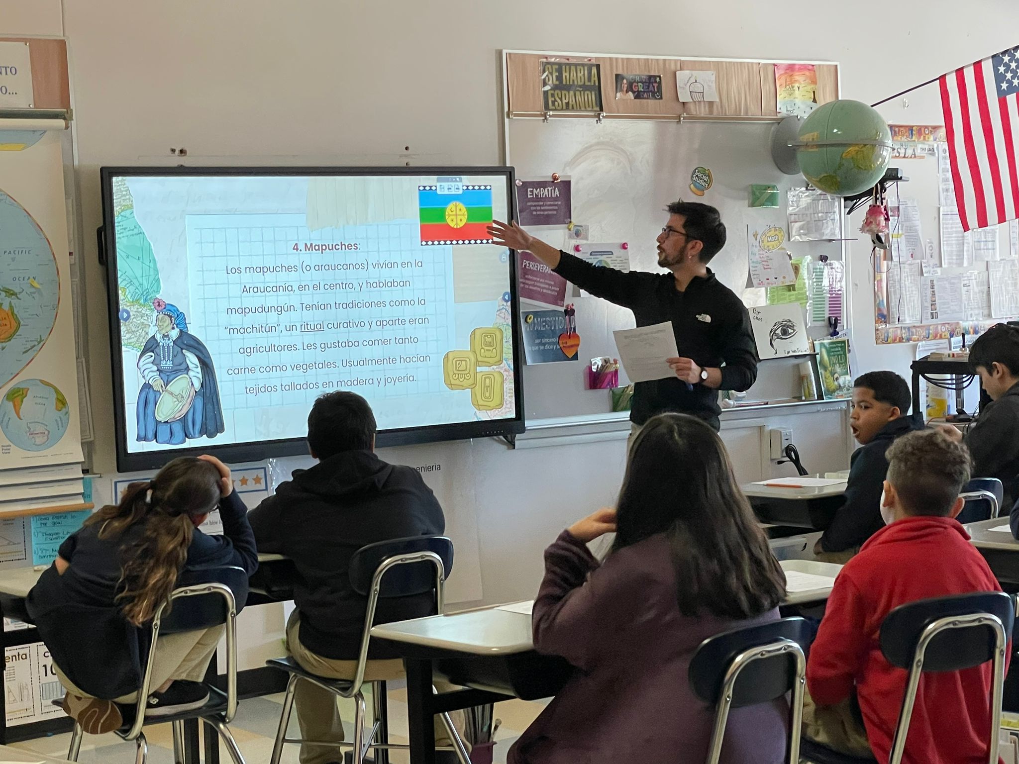 A participant of the ChileMass Teachers program teaches a class about the Mapuche people to students in a Massachusetts classroom, as part of the Boston immersion experience.